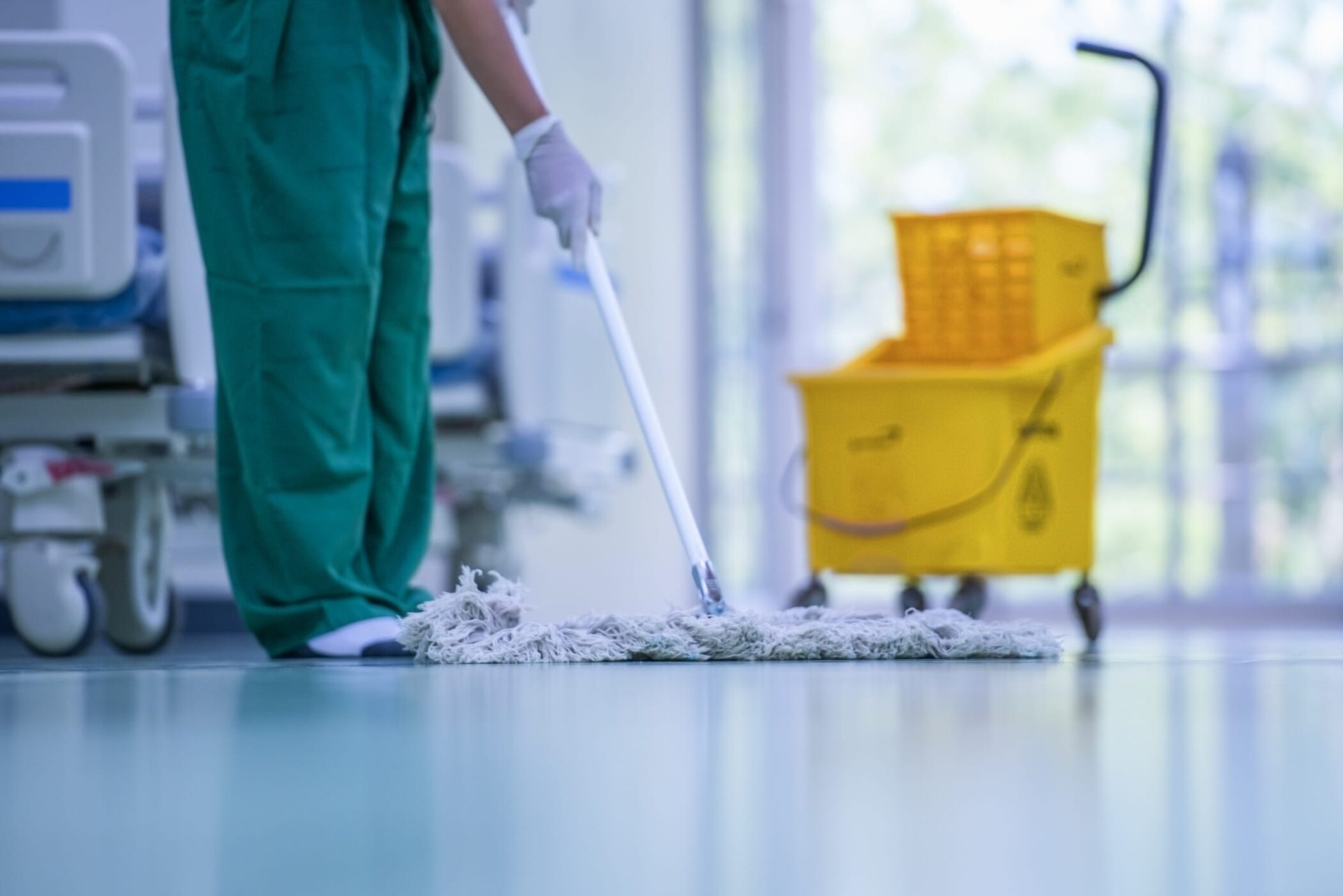 Close-up of cleaner or custodian mopping the floor.