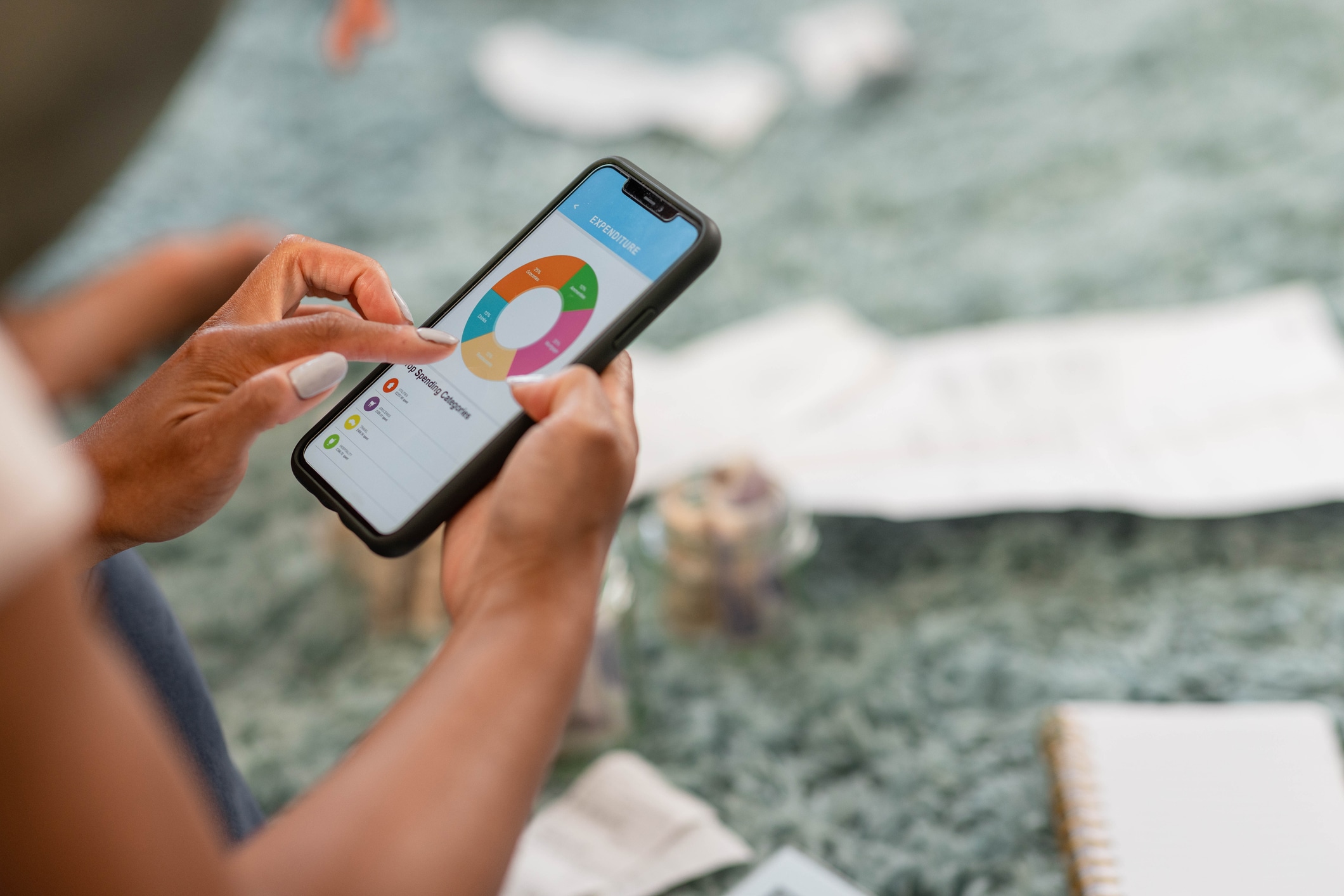 A person scrolling through their expenses on a smartphone.