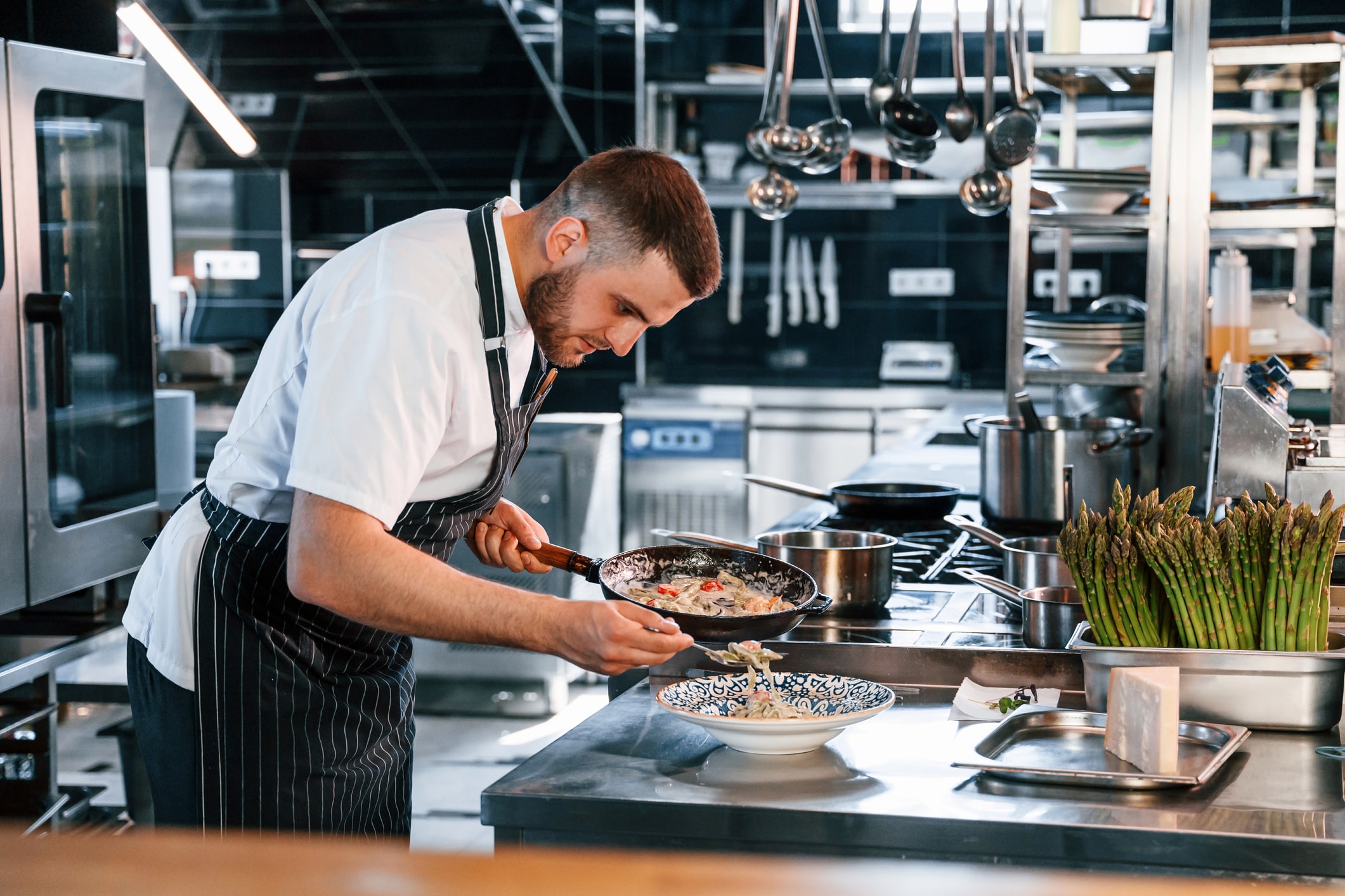Chef is on the kitchen preparing food.