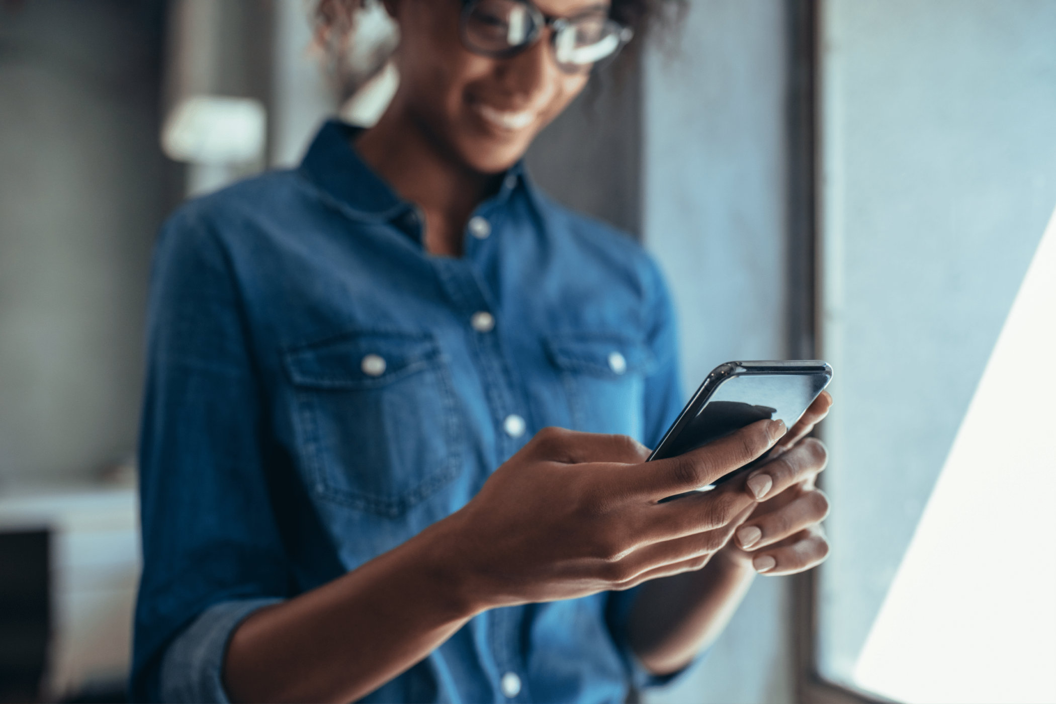 Unrecognisible smiling woman holding a phone